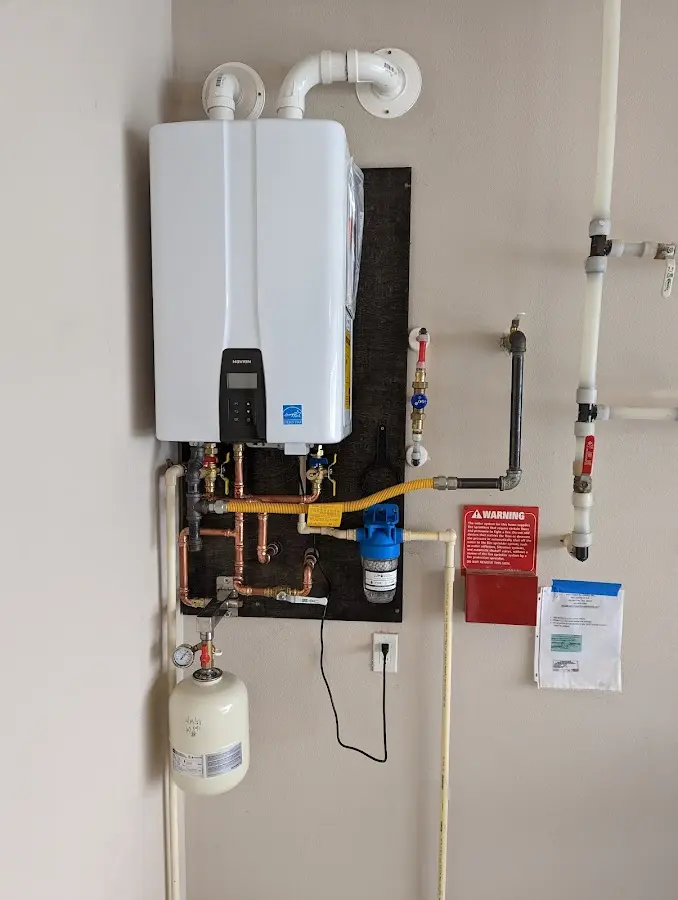 Professional plumber installing copper piping in a Upper Milford home